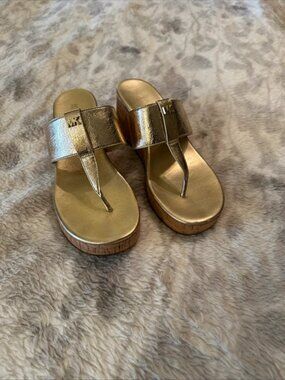 Michael Kors Zoe metallic gold wedge sandals featuring a cork wedge heel